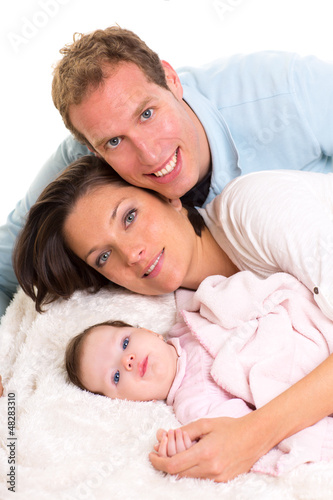 Photo: Baby girl mother and father family happy lying together Baby girl mother and father family happy lying together