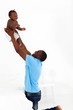 happy african american father and son playing in bedroom