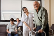 Nurse Helping Senior Patient With Walker