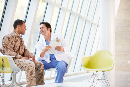 Photo: Doctor Counselling Soldier Suffering From Stress Doctor Counselling Soldier Suffering From Stress