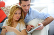 Cheerful young couple doing online shopping with tablet