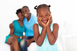 cute african little girl standing in front of parents