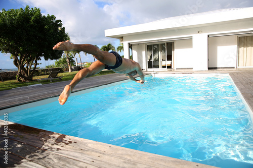 Photo: Man diving in private swimming-pool Man diving in private swimming-pool
