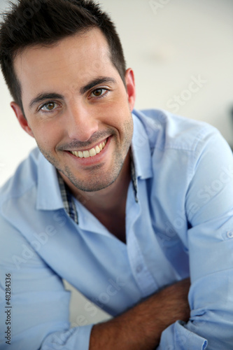 Photo: Portrait of handsome young man with blue shirt Portrait of handsome young man with blue shirt