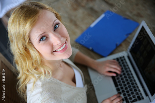 Photo: Upper view of blond woman using laptop Upper view of blond woman using laptop