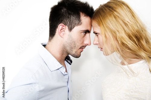 Photo: Couple on white background touching foreheads Couple on white background touching foreheads