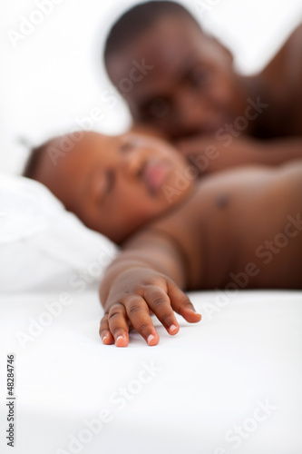 Photo: happy african father watching baby boy sleeping happy african father watching baby boy sleeping