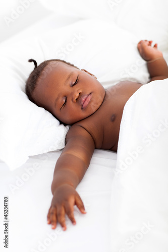 Photo: cute african american baby boy sleeping on bed cute african american baby boy sleeping on bed