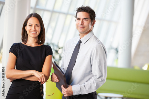 Photo: Businessman And Businesswomen Having Meeting In Office Businessman And Businesswomen Having Meeting In Office