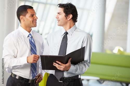 Photo: Two Businessmen Having Informal Meeting In Modern Office Two Businessmen Having Informal Meeting In Modern Office