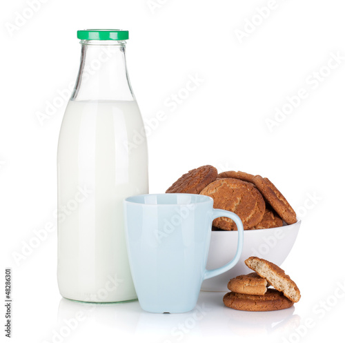 Photo: Cup, bottle of milk and bowl with cookies Cup, bottle of milk and bowl with cookies