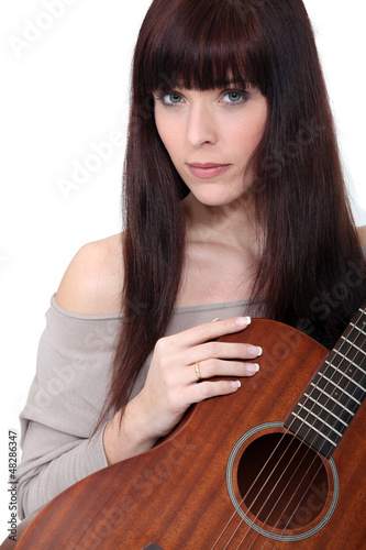 Photo: Woman holding guitar Woman holding guitar