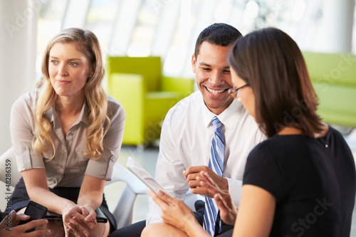 Photo: Businesspeople With Digital Tablet Having Meeting In Office Businesspeople With Digital Tablet Having Meeting In Office
