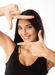 Photo: Portrait of young beautiful woman making frame with her hands Portrait of young beautiful woman making frame with her hands