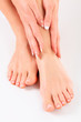 Photo: Well-groomed hands on female feet Well-groomed hands on female feet