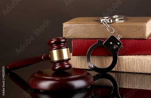 Photo: Gavel, handcuffs and.books on law isolated on black Gavel, handcuffs and.books on law isolated on black