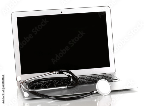 Photo: Silver notebook with a stethoscope isolated on white Silver notebook with a stethoscope isolated on white