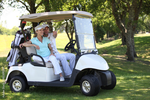 Photo: Couple in golf buggy Couple in golf buggy