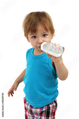 Photo: cute little boy with bottle of milk, isolated on white cute little boy with bottle of milk, isolated on white