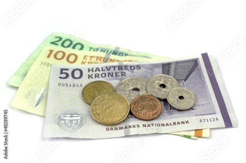 Photo: Danish kroner, coins and banknotes on white background. Danish kroner, coins and banknotes on white background.