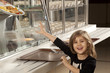 little girl in cafeteria line trying to take her healthy meal 