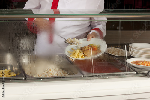 Photo: chef standing behind full lunch service station chef standing behind full lunch service station