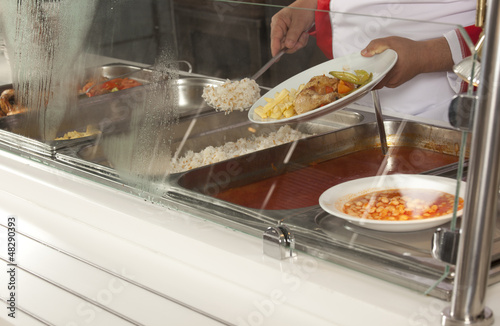 Photo: chef standing behind full lunch service station chef standing behind full lunch service station