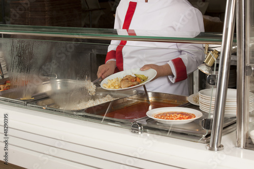 Photo: chef standing behind full lunch service station chef standing behind full lunch service station