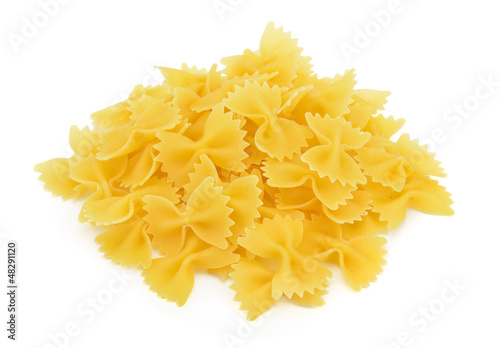 Photo: Heap of farfalle pasta isolated on white background Heap of farfalle pasta isolated on white background