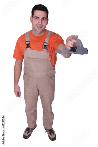 Photo: Handyman holding tool Handyman holding tool