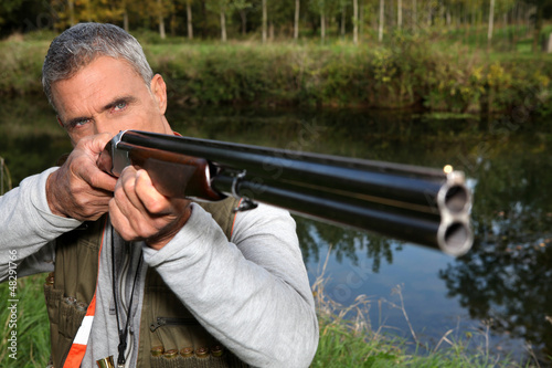 Photo: a hunter aiming for a target a hunter aiming for a target