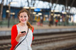 Pretty young woman at a train station