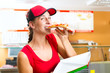Woman eating a slice of pizza