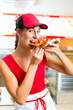 Woman eating a slice of pizza