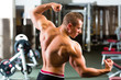 Bodybuilder posing in Gym