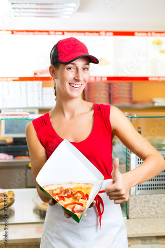 Photo: Woman eating a slice of pizza Woman eating a slice of pizza