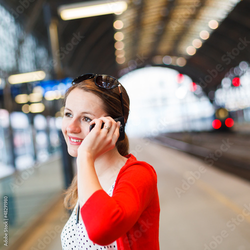 Photo: Pretty young woman at a train station Pretty young woman at a train station