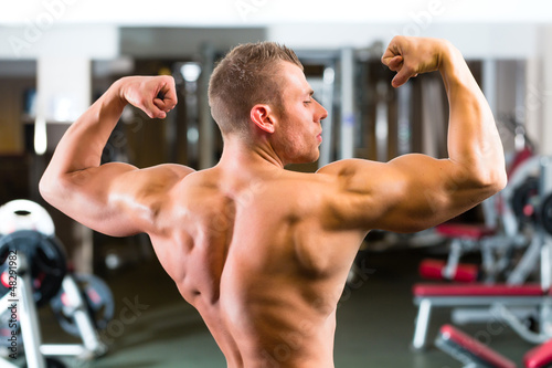 Photo: Bodybuilder posing in Gym Bodybuilder posing in Gym