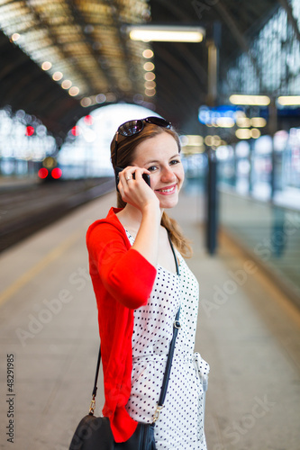 Photo: Pretty young woman at a train station Pretty young woman at a train station