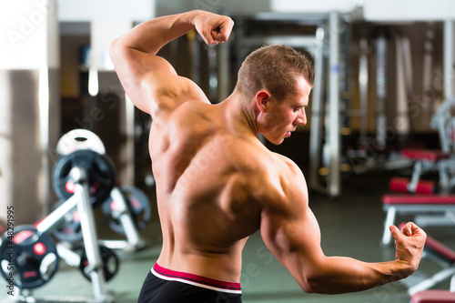 Photo: Bodybuilder posing in Gym Bodybuilder posing in Gym