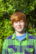 portrait of attractive happy smiling boy in the garden
