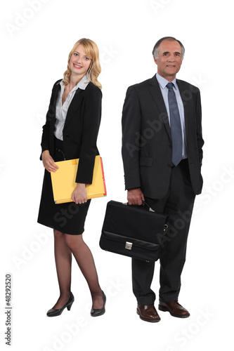 Photo: senior businessman and young assistant posing together senior businessman and young assistant posing together