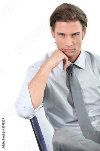 Photo: Young businessman leaning on his chair Young businessman leaning on his chair