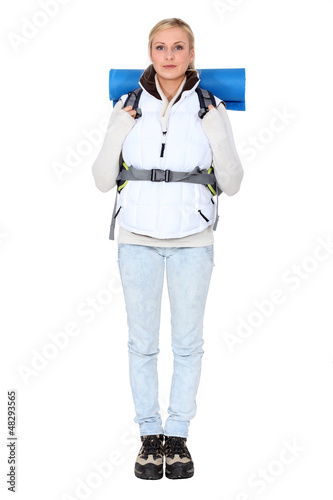 Photo: Studio portrait of a female backpacker Studio portrait of a female backpacker