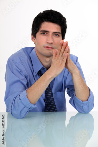 Photo: Businessman with his hands pressed together Businessman with his hands pressed together