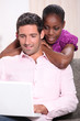 Couple looking at a laptop computer at home