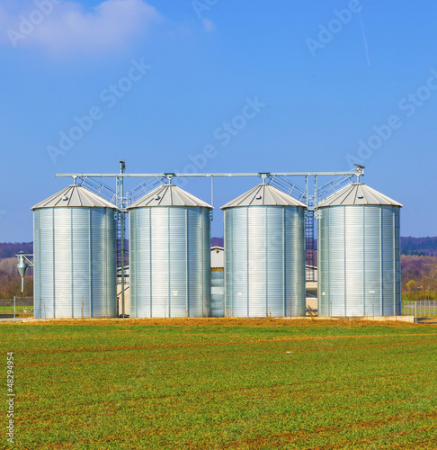 Photo: silver silos in field silver silos in field