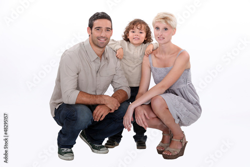 Photo: Studio shot of young family Studio shot of young family