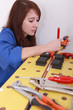 Female plumber cutting copper pipe