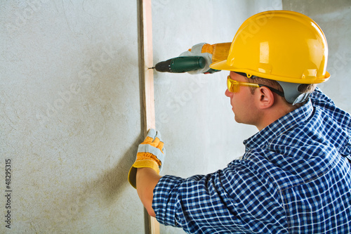 Photo: a contractor working with electrical screwdriwer a contractor working with electrical screwdriwer